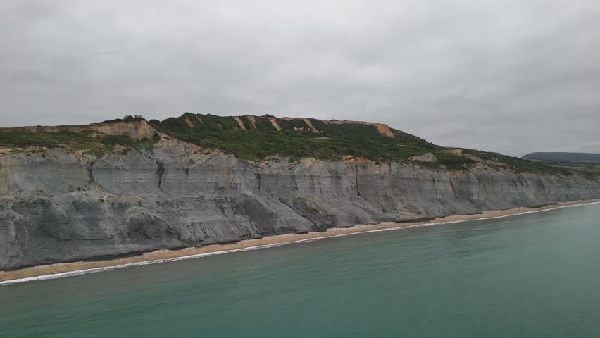 aerial Close Up View of Layered Cliff Face and Turquoise Sea on Jurassic Coast in Dorset England