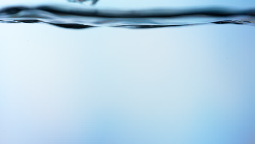 Super Slow Motion Shot of Clear Ice Cubes Falling into Water at 1000fps.