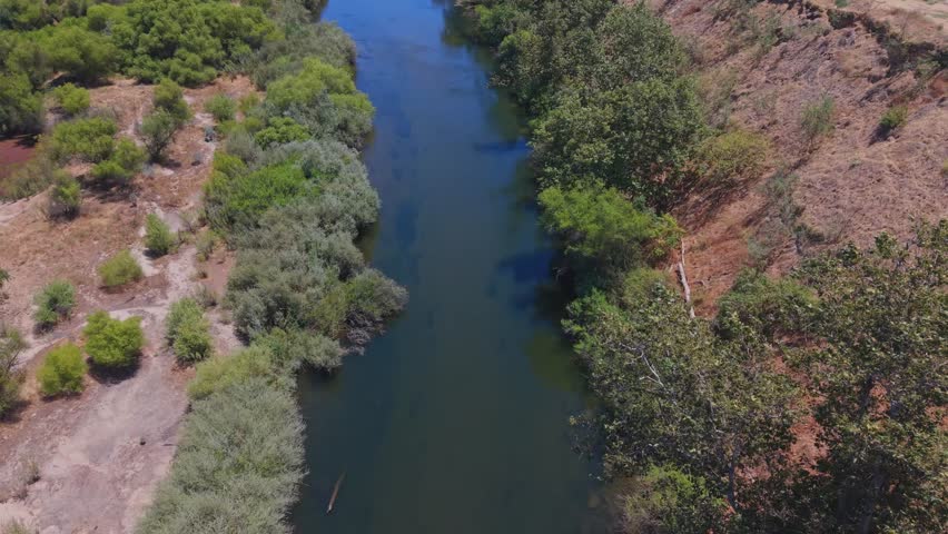 Aerial drone footage moving forward over the San Joaquin River in California