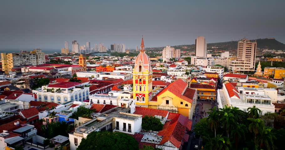 Catedral de Santa Catalina de Alejandría in Cartagena, Colombia, with colourful colonial architecture, rooftops and city skyline, cinematic aerial view