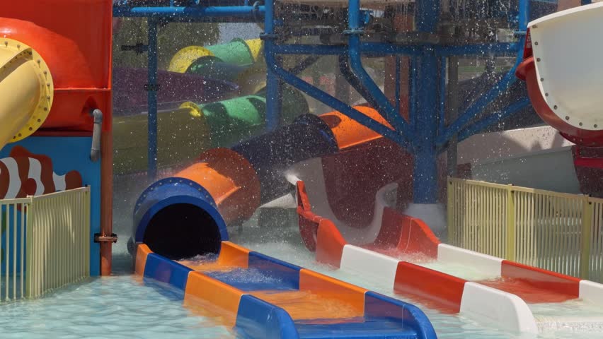 A close up view shows a colorful striped slide tunnel at an aqua park in Cesme Turkey
