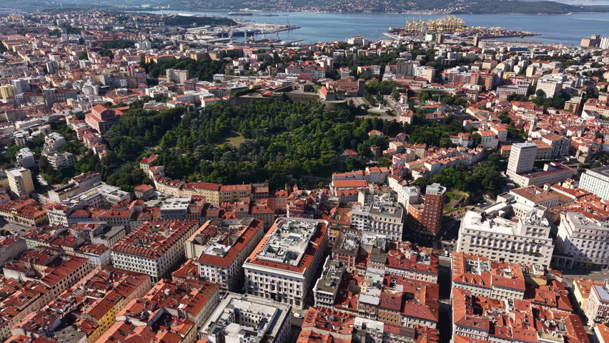 Aerial View of Trieste, Italy, Old Town, Castle and City Harbor, Establishing Drone Shot