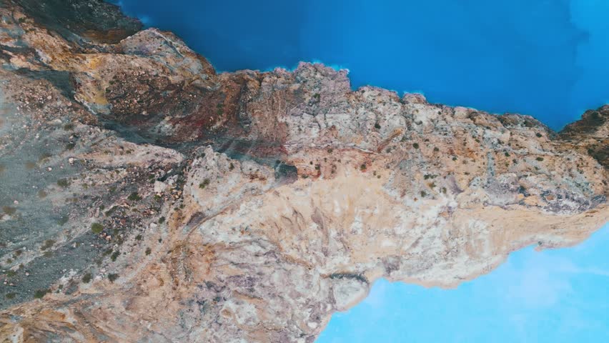 High Angle Shot Revealing Dramatic Gradient Transition in Mineral Water of Crater Lake. Beautiful Indonesian Landmark Captured from Bird Eye View Showing Unique Geological Natural Phenomenon 4k