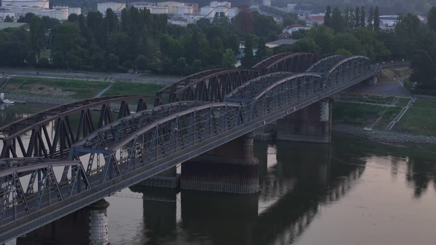 Ponte di Ferro crossing the Po River between Cremona, Lombardy, and Castelvetro Piacentino, Emilia-Romagna, Italy, revealing exposed riverbanks during low water conditions, drone establishing shot.