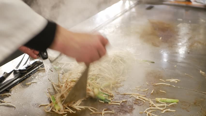 POV motion while chef is cooking stir fried bean sprout of Yasai Itame fried vegetable in japanese style,japanese style sidedish for kobe beef steak meal