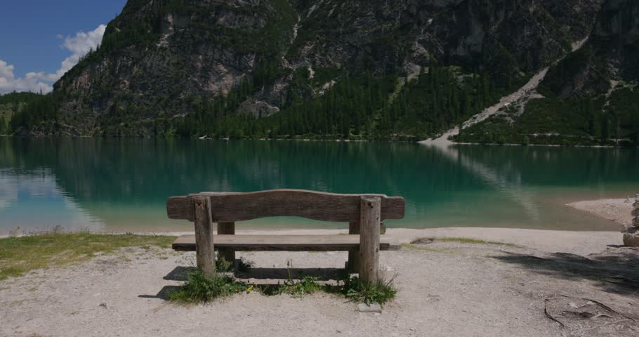 Rustic Wooden Bench Overlooking The Crystal-clear Pragser Wildsee (Lago di Braies) In The South Tyrol Region Of Italy. Static Shot