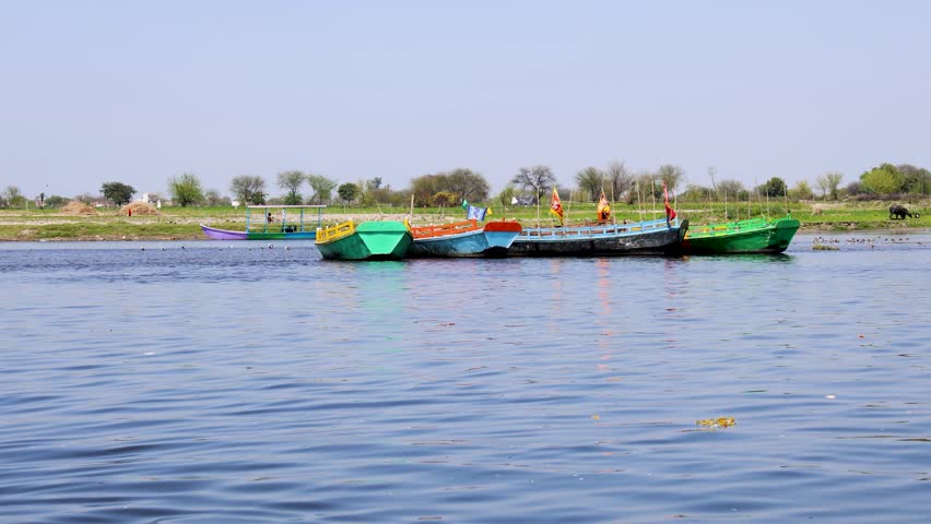 scenic riverside view featuring colorful boats and serene freshwater environment