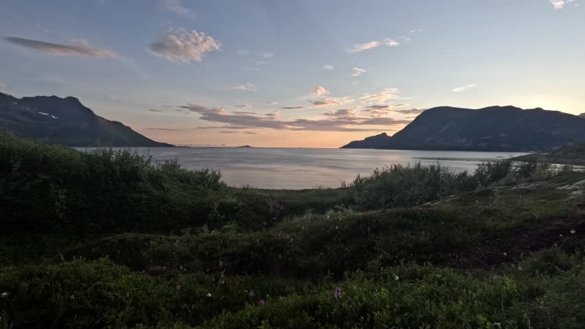 Norwegian fjord with changing colors during a midnight sun