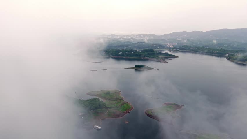 Aerial photography of islands in the lake under clouds and mist	
