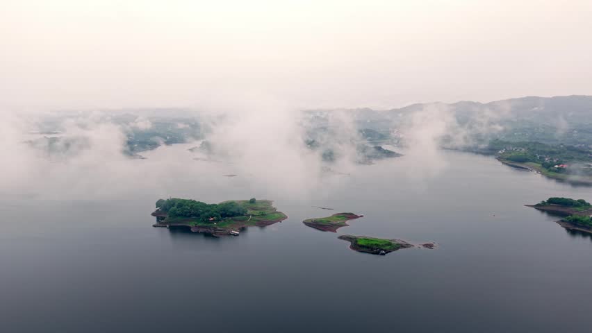 Aerial photography of islands in the lake under clouds and mist	
