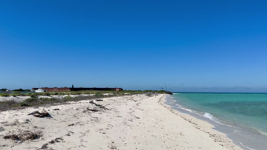 Panoramic, scenic view of Garden Key island and Fort Jefferson. Historical masonry brick fortress surrounded by water. Birds are flying around.  Dry Tortugas National Park, Florida 