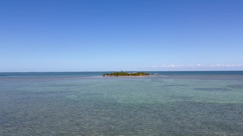 Panoramic, scenic view of Little Money Key and Ocean. Person paddles around the island. Motion of water. View from Seven Mile Bridge. Florida Keys, Florida 