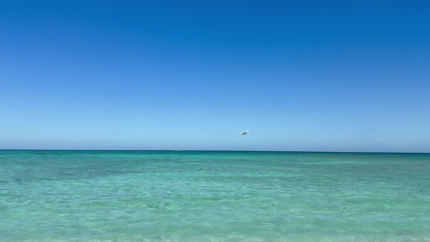 Sea Plane flies over Bush Key Shoal. Panoramic, scenic view from Fort Jefferson. Waves of emerald blue water. Dry Tortugas National Park, Florida