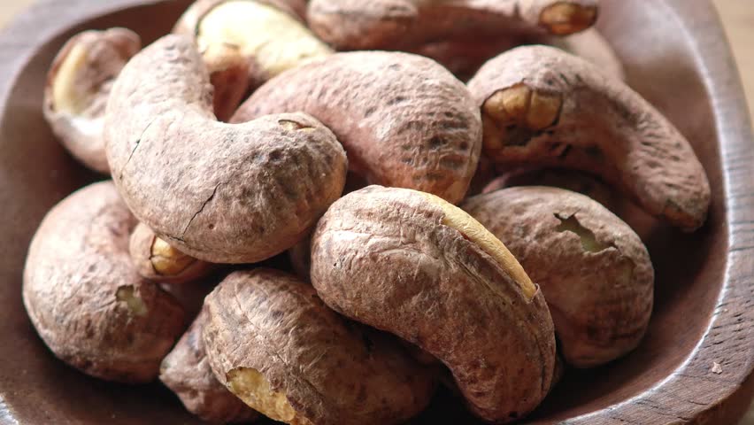 Roasted Cashew Nuts in a Wooden Bowl on Rustic Background