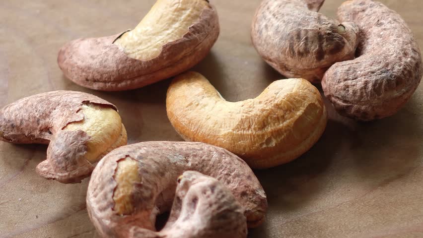 Roasted Cashew Nuts in a Wooden Bowl on Rustic Background