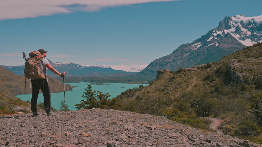 Backpacking hiker enjoying amazing view from Torres del Paine national park on the W Trek, Patagonia, Chile