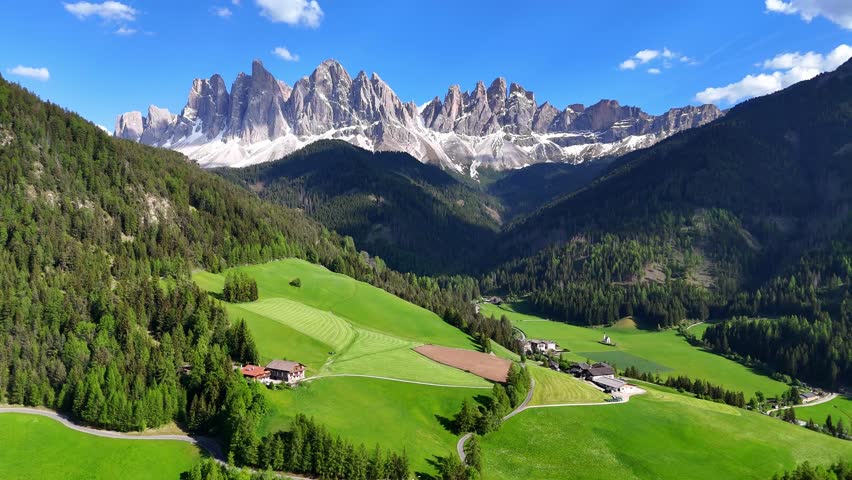 Aerial drone view of Santa Maddalena (Magdalena) village with the Dolomite mountains in the background. Val di Funes valley, Trentino-Alto Adige region. Italy, Europe.