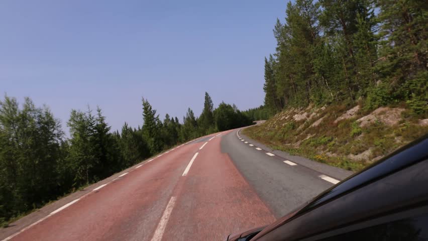 Idre, Sweden A car rides on forest road in the Dalarna region. 