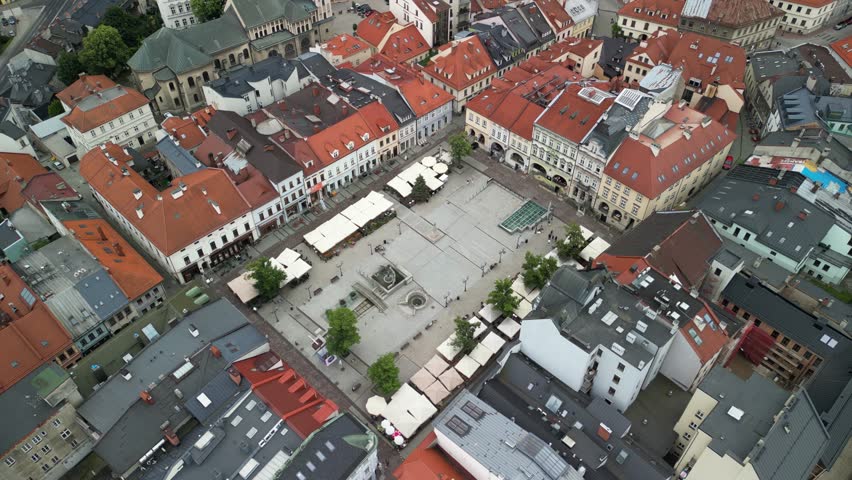 Bielsko-Biała, Poland 07 15 2026
High-quality aerial drone footage of the market square and city skyline. Market square, mountains, peaks, townhouses, church.