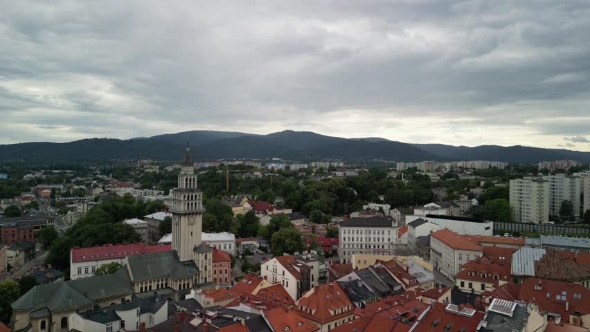 Bielsko-Biała, Poland 07 15 2026
High-quality aerial drone footage of the market square and city skyline. Market square, mountains, peaks, townhouses, church.