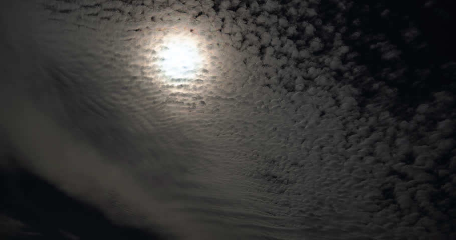 Sun burns through a bank of Cirrocumulus clouds in an afternoon sky.