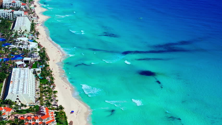 Aerial view of white-sand beach and resorts along the turquoise Caribbean coast of the Cancun Hotel Zone, Quintana Roo, Mexico.