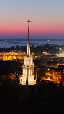 Twilight aerial view of Newport Rhode Island with church steeple and Pell Bridge at dusk. g.