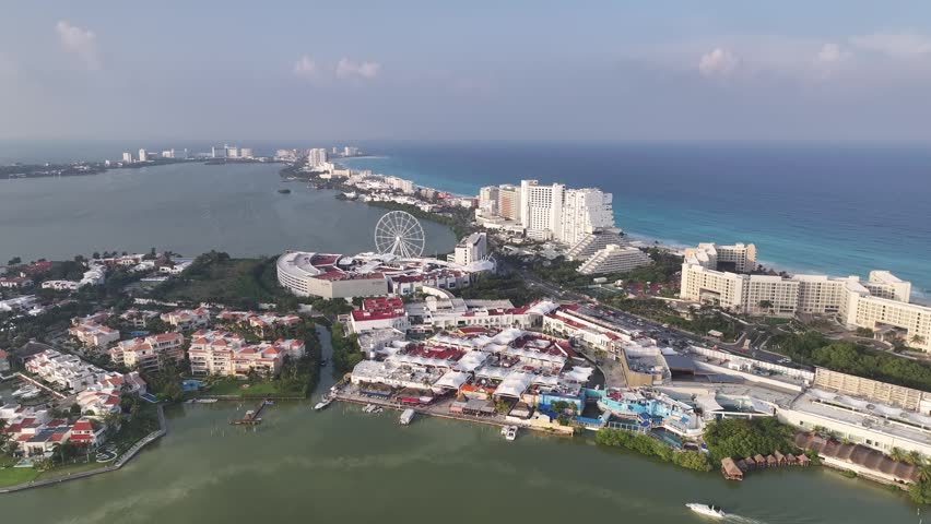 Aerial view of the Hotel Zone and Ferris wheel in Cancun, featuring luxury resorts and the Nichupte Lagoon in Cancun, Quintana Roo, Mexico.