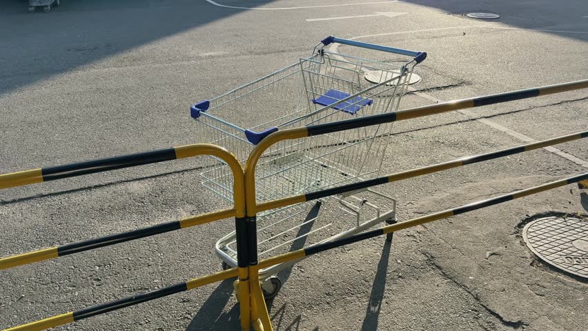 Empty Shopping Cart Abandoned in Parking Lot Urban Retail Scene