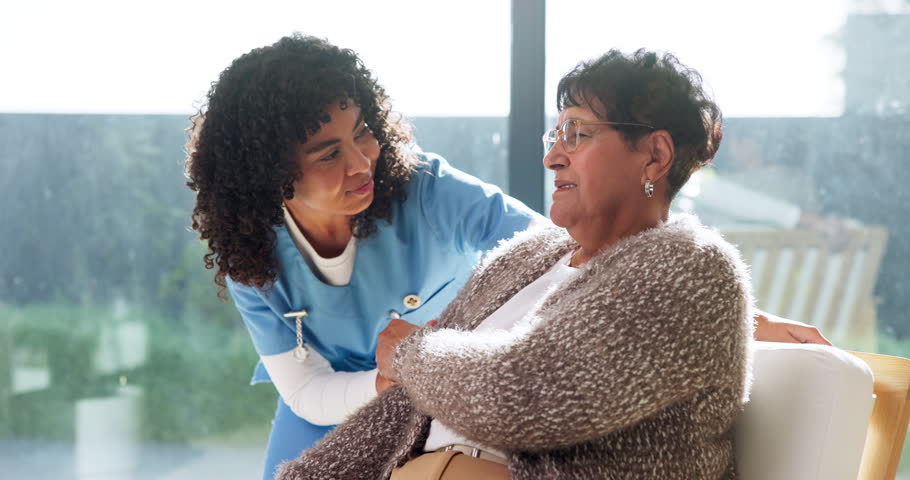 Healthcare, nurse and talking with old woman on sofa in retirement home for assisted living. Checkup, communication and visit with caregiver speaking to happy senior patient in apartment for service