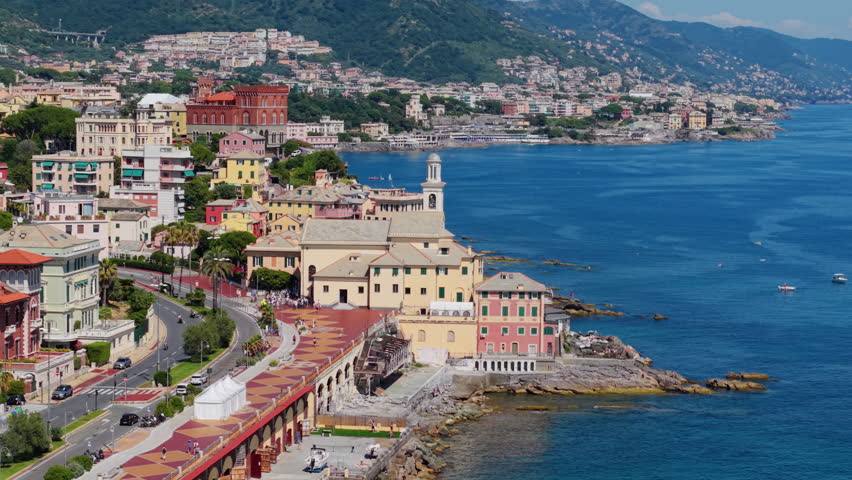 Colorful coastal buildings and church by the sea in Genova, Italy, seen from above