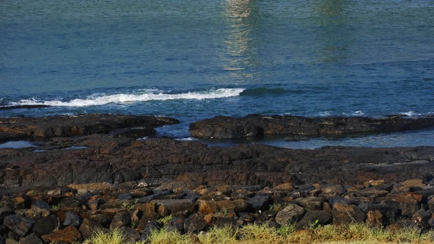 Ocean Waves Crashing on Rocky Shore Along the Mumbai Coast, India	
