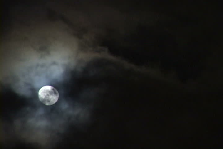 Time Lapse of Bright, Full Moon at night as clouds move passed.