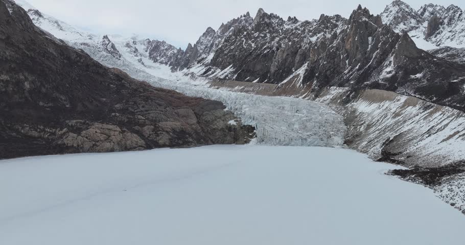 Beautiful high altitude hanging glacier and snow capped mountain with lake in Tibet, China