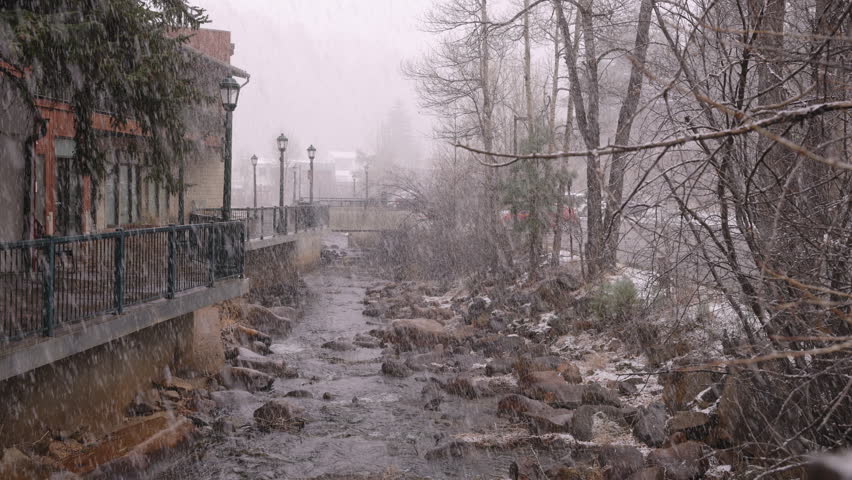 Snow falling on the stream in the historic downtown of Estes Park, Colorado