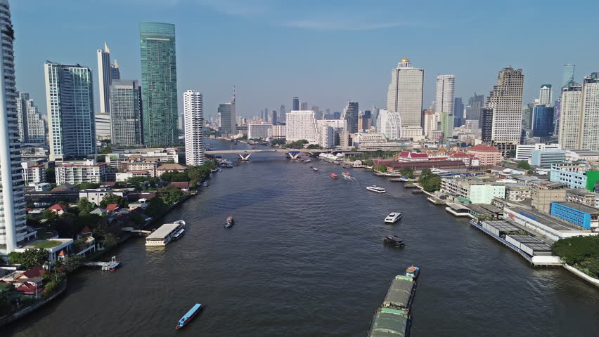 Aerial high view of skyscrapers in Bangkok city and Chao Phraya River, 4k