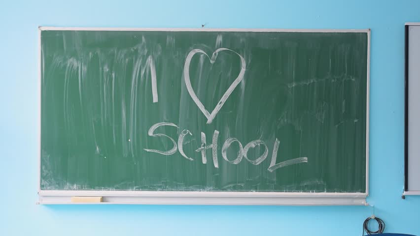 I love school written on blackboard. Chalkboard handwriting with I love school message.