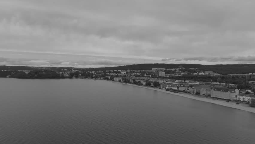 Aerial view of a serene coastal town under a cloudy sky