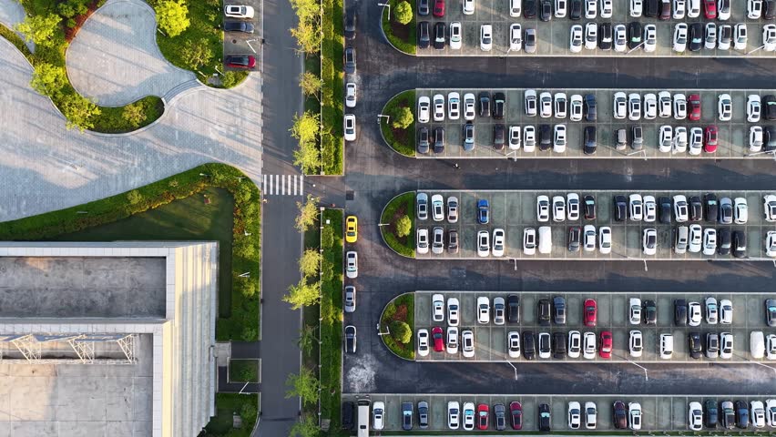 aerial view of neat landscaped outdoor parking lot full of cars