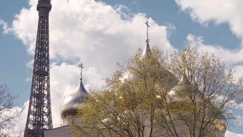 Eiffel Tower and Golden Domes of Holy Trinity Cathedral Russian Orthodox Center in Paris against Cloudy Sky, Static Shot