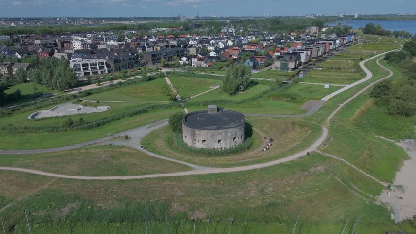 Drone view circling around Westbatterij in Muiden, showing the historic fort structure and surrounding green landscape from above.