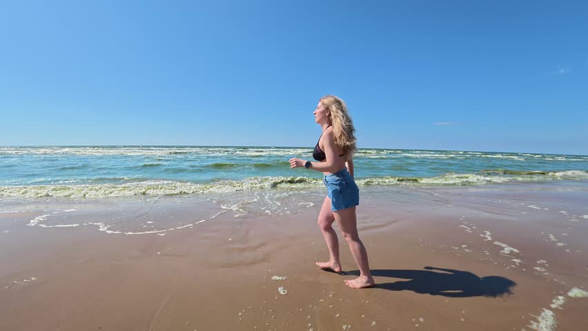Young woman enjoying the sea and summer vacation on a sunny beach