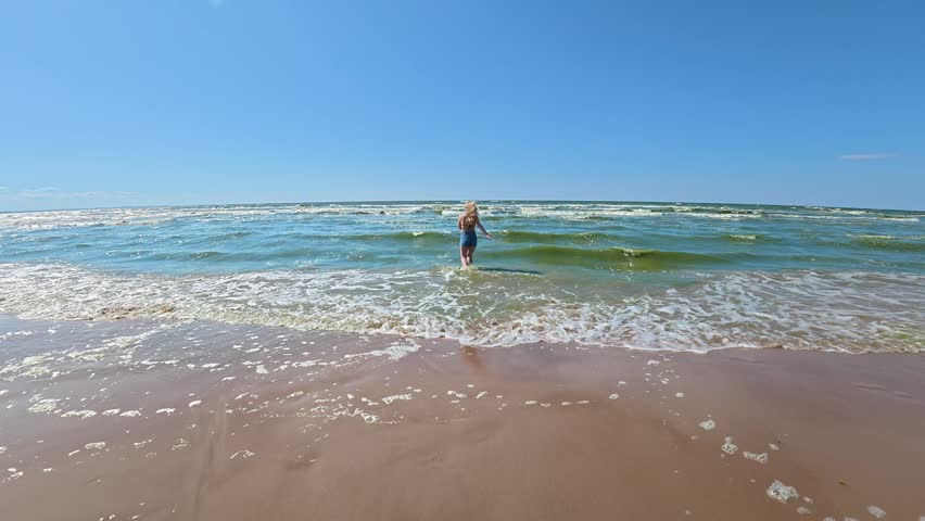 Young woman enjoying the sea and summer vacation on a sunny beach