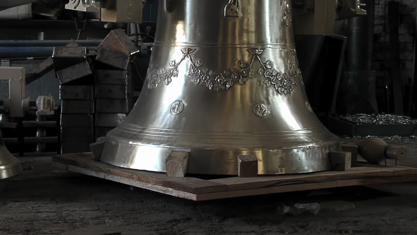 Polished Bronze Church Bell Suspended On Hoist Inside Traditional Foundry - 4K