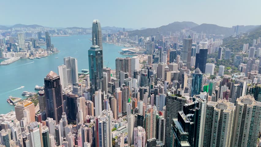 Flight above urban landscape and view of bay straight the high-rise skyscrapers of Hong Kong city