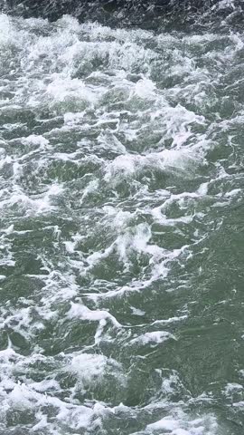 Close-up of rushing whitewater rapids flowing over rocks in 4K