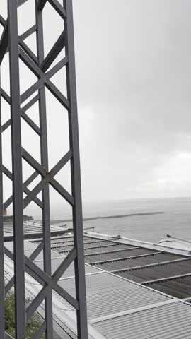 Dramatic storm clouds gathering over the sea at a coastal restaurant