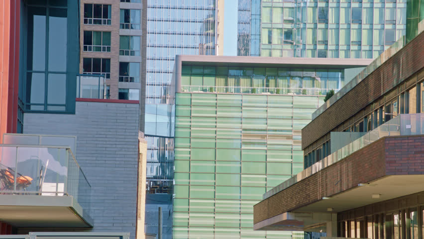 Cinematic 4K footage of modern residential and commercial high-rise buildings in downtown Toronto, Ontario, Canada. Features contemporary architecture, glass facades, urban development, luxury condominiums, construction, and city skyline details suitable for business, real estate, architecture, finance, corporate, and travel productions.