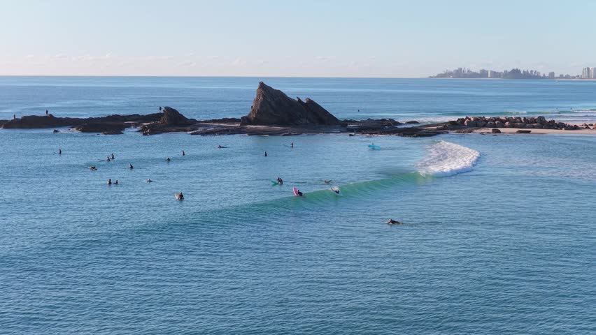 Currumbin Rock And Surfers At Surfing Spot In Currumbin Alley on the Gold Coast in Queensland, Australia. - aerial shot