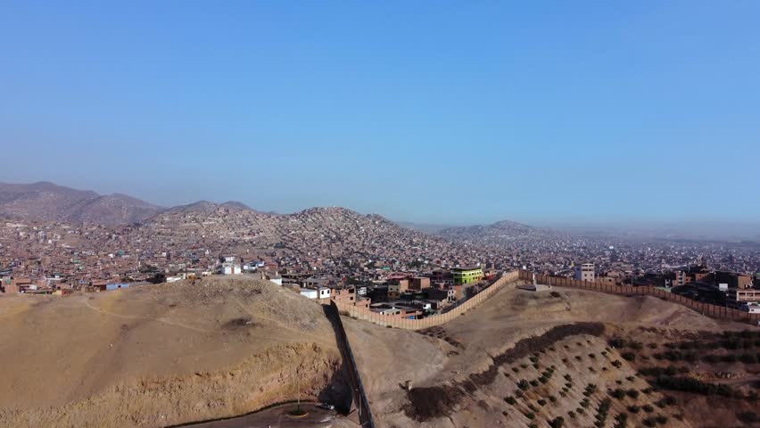 Aerial view of the Wall of Shame separating San Juan de Miraflores and Santiago de Surco districts in Lima, Peru.